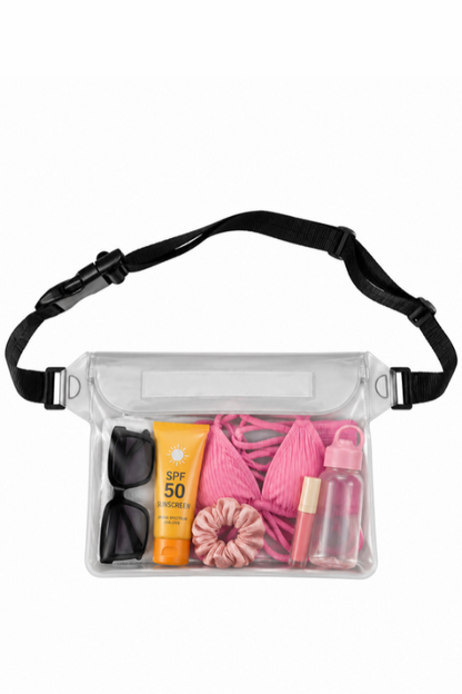 A clear waterproof pouch with a black adjustable strap, shown filled with travel accessories including pink swimwear, sunglasses, sunscreen, a hair scrunchie, and a lip balm, on a plain white background.